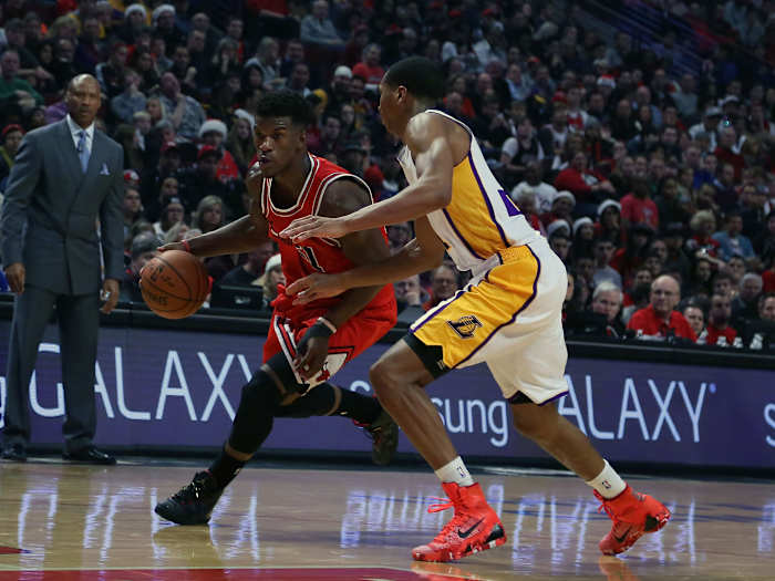 Chicago Bulls guard Jimmy Butler dribbles past Los Angeles Lakers forward Wesley Johnson.